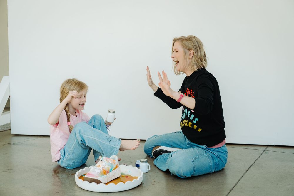 Wizzy Fizzies founder Angie mixing colors with her kids during a Denver brand photography session with McGlone Photography.