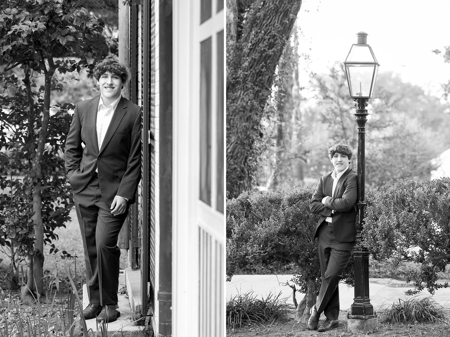 Black and white senior portrait of a young man posing by a door and lamppost in a classic suit.