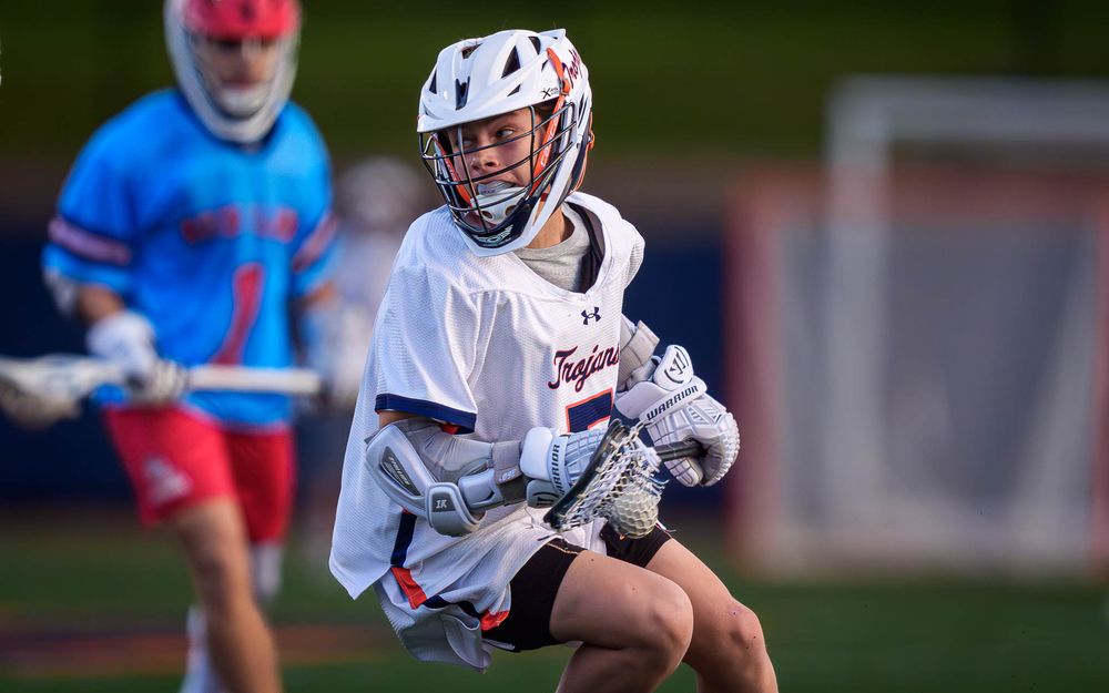 Hershey Trojans lacrosse player dodging, home game vs. Red Land by Deanna Fox, SportsFox Photography based in Hershey PA