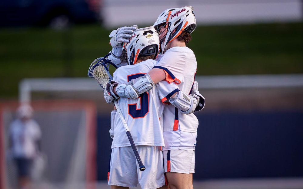 Hershey Trojans players celebrate vs. Red Land, boys lacrosse home opener by Deanna Fox, SportsFox Photography based in Hershey PA