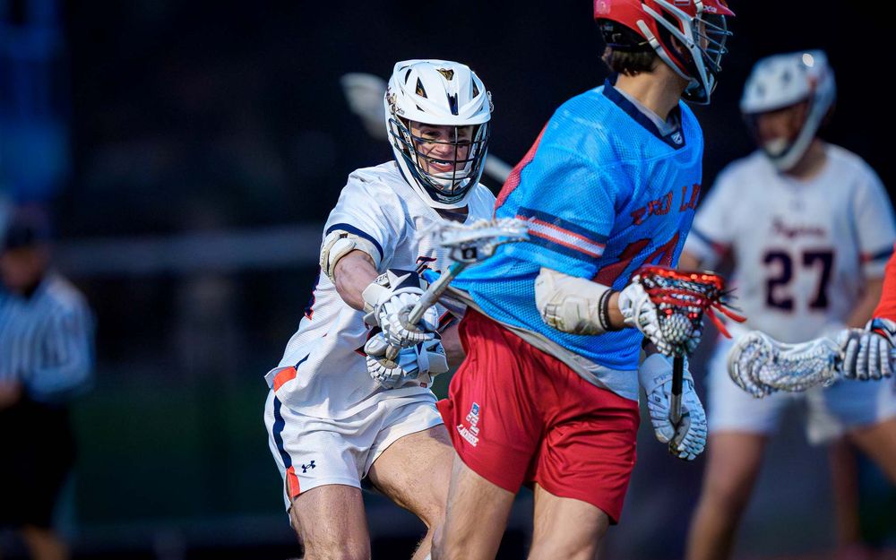 Hershey Trojans midfielder checks Red Land attacker, boys lacrosse by Deanna Fox, SportsFox Photography based in Hershey PA