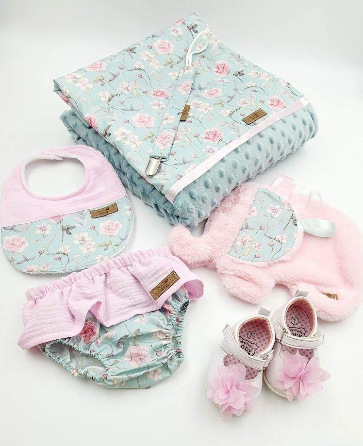 Floral mint and pink baby gift set with blanket, bib, bloomers, booties, and jacket.