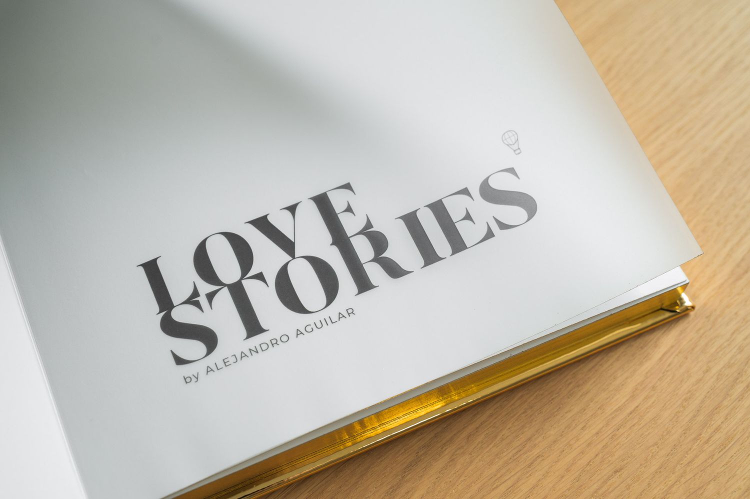 Interior title page of Love Stories by Alejandro Aguilar photo book with gold page edges.