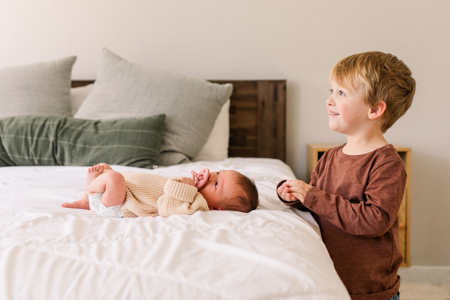 Richmond, Virginia newborn photography capturing big brother doting on his new baby sister.