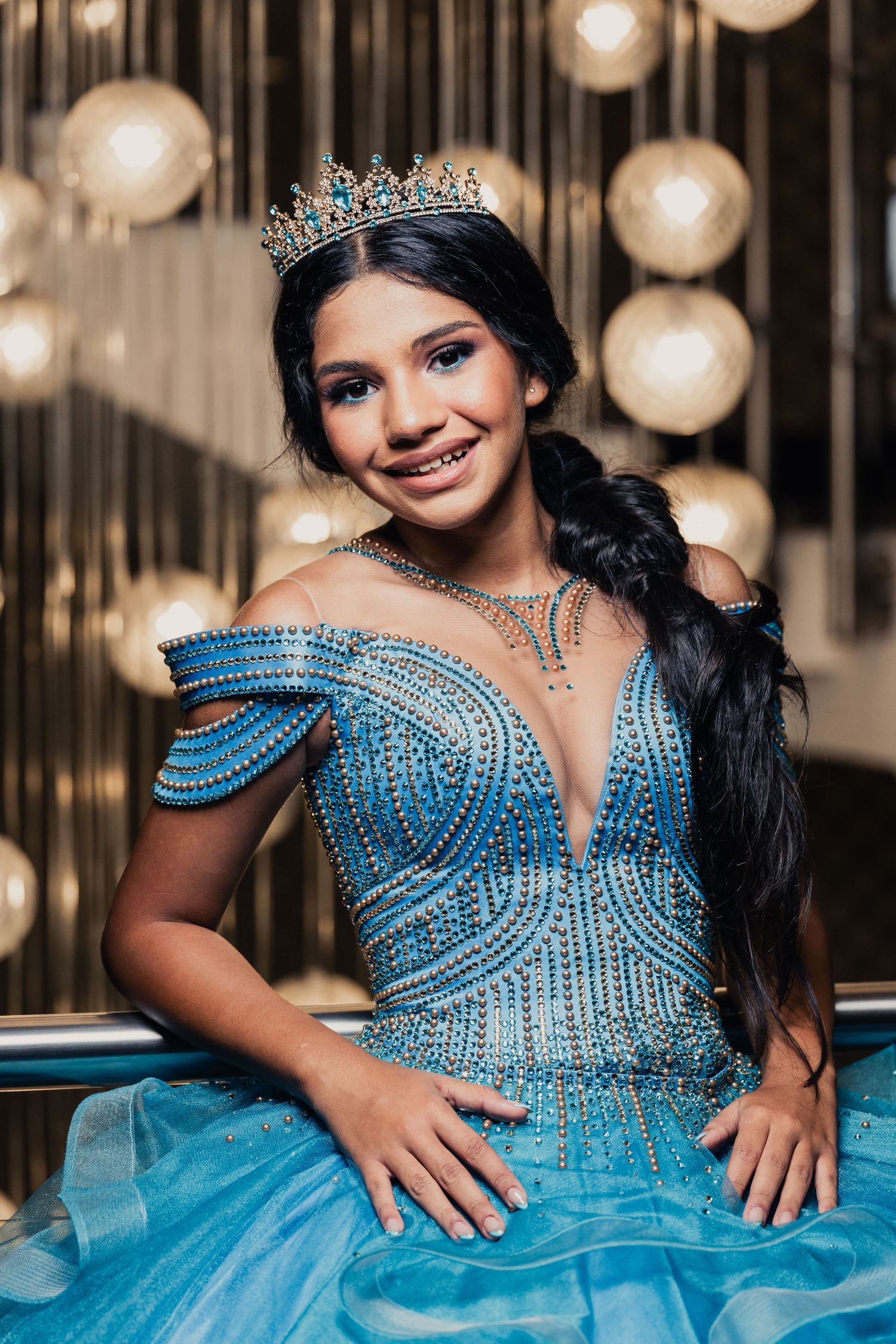 Stunning blue quinceañera dress with crystal beading and sweetheart neckline sparkles under elegant lighting.
