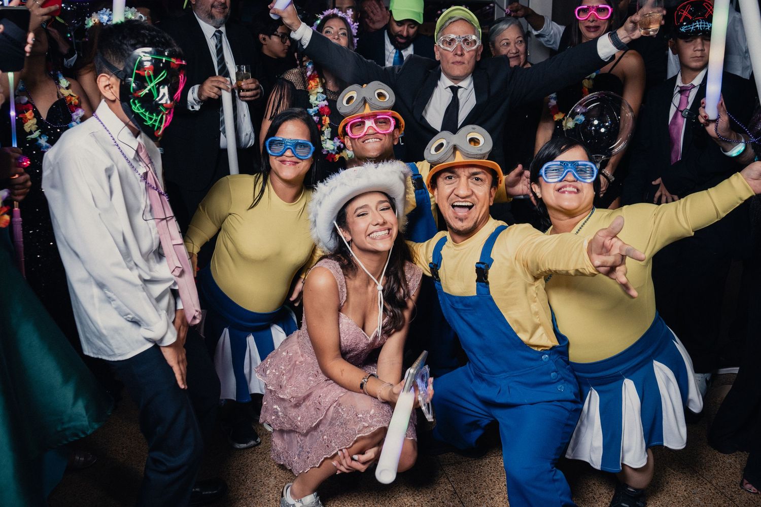 Energetic crowd dancing and celebrating at a lively wedding reception or party.