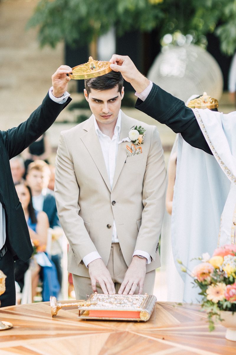 Wedding ceremony moment with couple at wooden table during outdoor celebration.