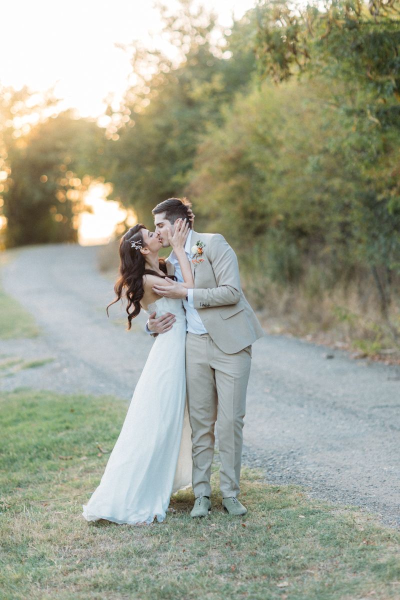 Romantic wedding portraits on a gravel path with natural outdoor lighting.