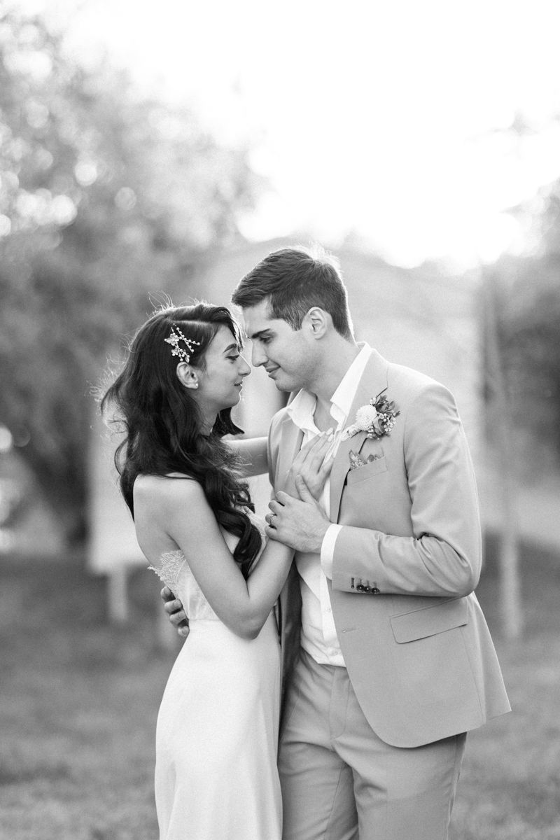 Black and white wedding portraits capturing intimate moments between newlyweds.