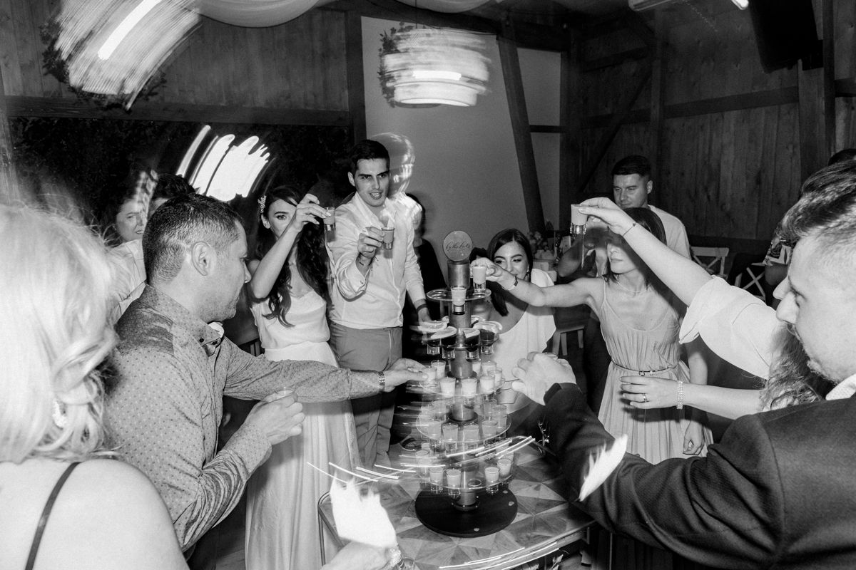 Black and white candid shots of wedding reception guests enjoying the celebration.