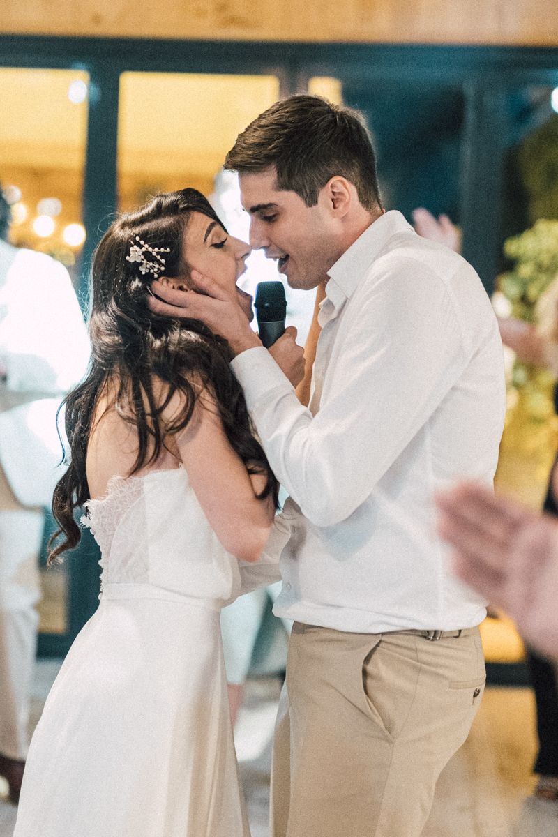 Romantic first dance sequence at a wedding reception with couple in white dress and khaki pants.