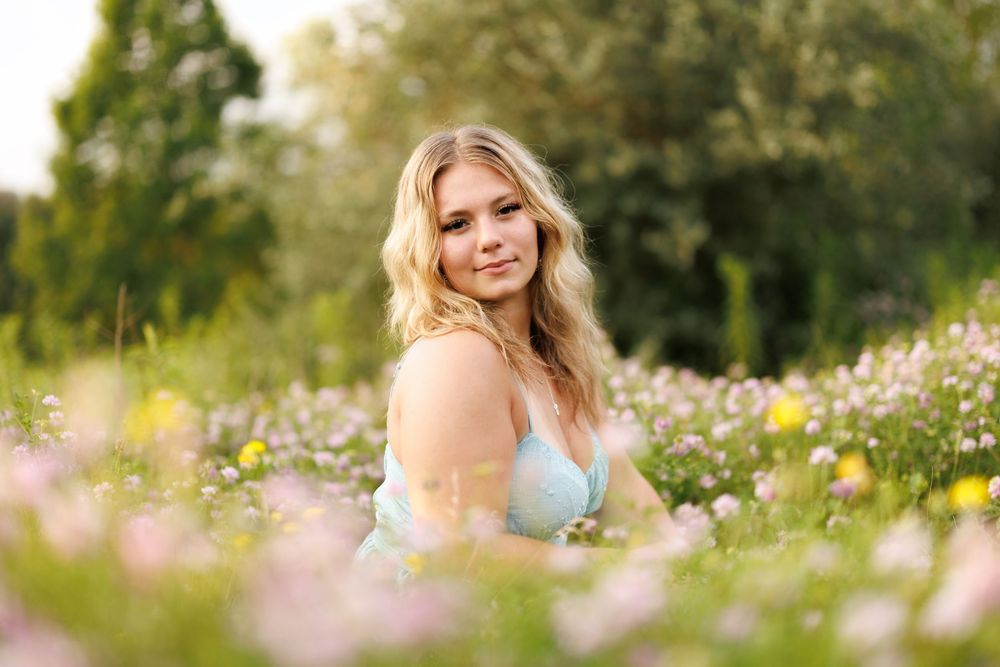 Candid outdoor portraits captured in a flowering meadow during golden hour.