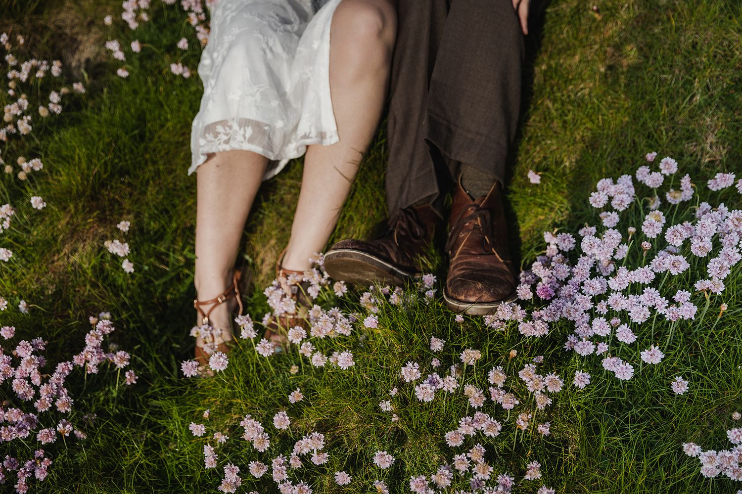 Spring elopement portraits at Cliffs of Moher featuring blooming sea thrift wildflowers