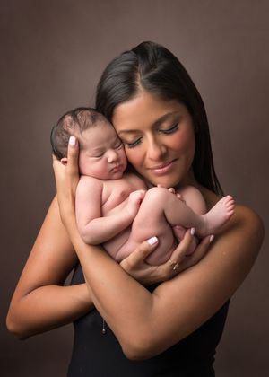 A tender moment between a mother and newborn baby in a series of intimate black and white portraits.