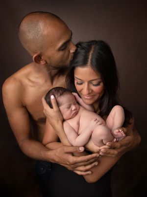 A series of intimate family portraits in sepia tones showing tender moments between parents and newborn.