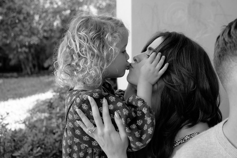 Black and white film stills showing romantic embraces and kisses between couples in classic cinema.