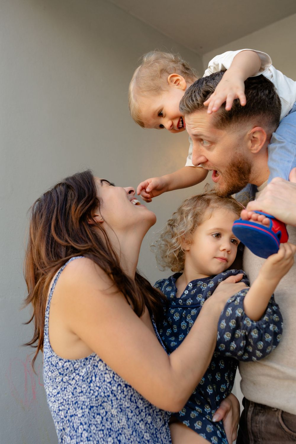 A joyful family sharing playful moments together with their children in a candid portrait.