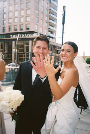 A wedding couple shares playful laughter in a series of three photos outside a city building.