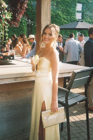 Outdoor patio area with wooden benches and deck seating for wedding guests.