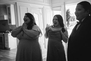 A series of black and white photos showing silhouettes of people hugging and embracing in an indoor space.