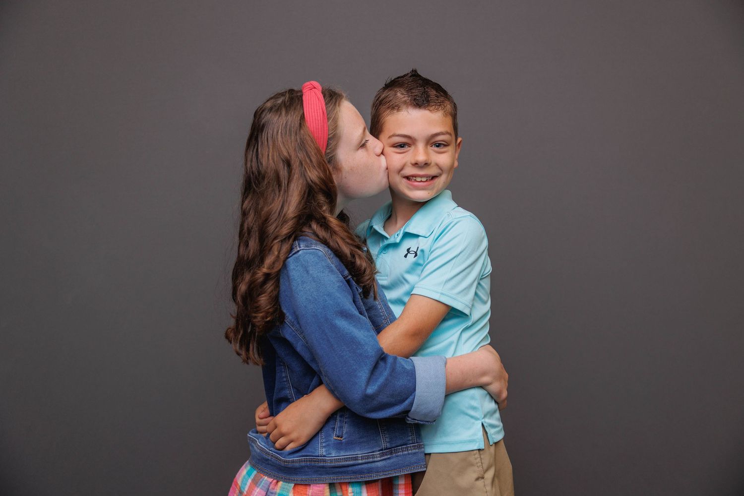 A series of candid family photos showing tender moments between loved ones in coordinated blue and pink outfits.