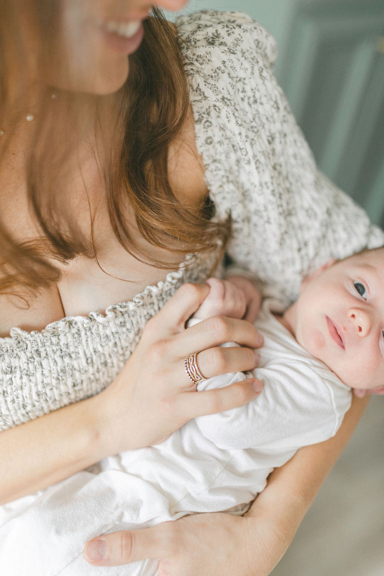 A series of tender moments between parent and newborn baby shown in soft, neutral-toned photographs.