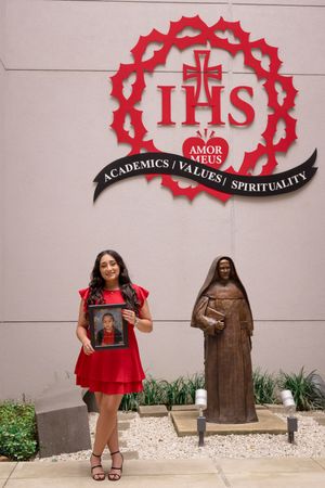 Red decorative wall art and statues create an academic and spiritual atmosphere against white wall.