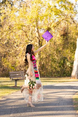 Playful Halloween themed photoshoot with candy and purple trick-or-treat bag in autumn setting.