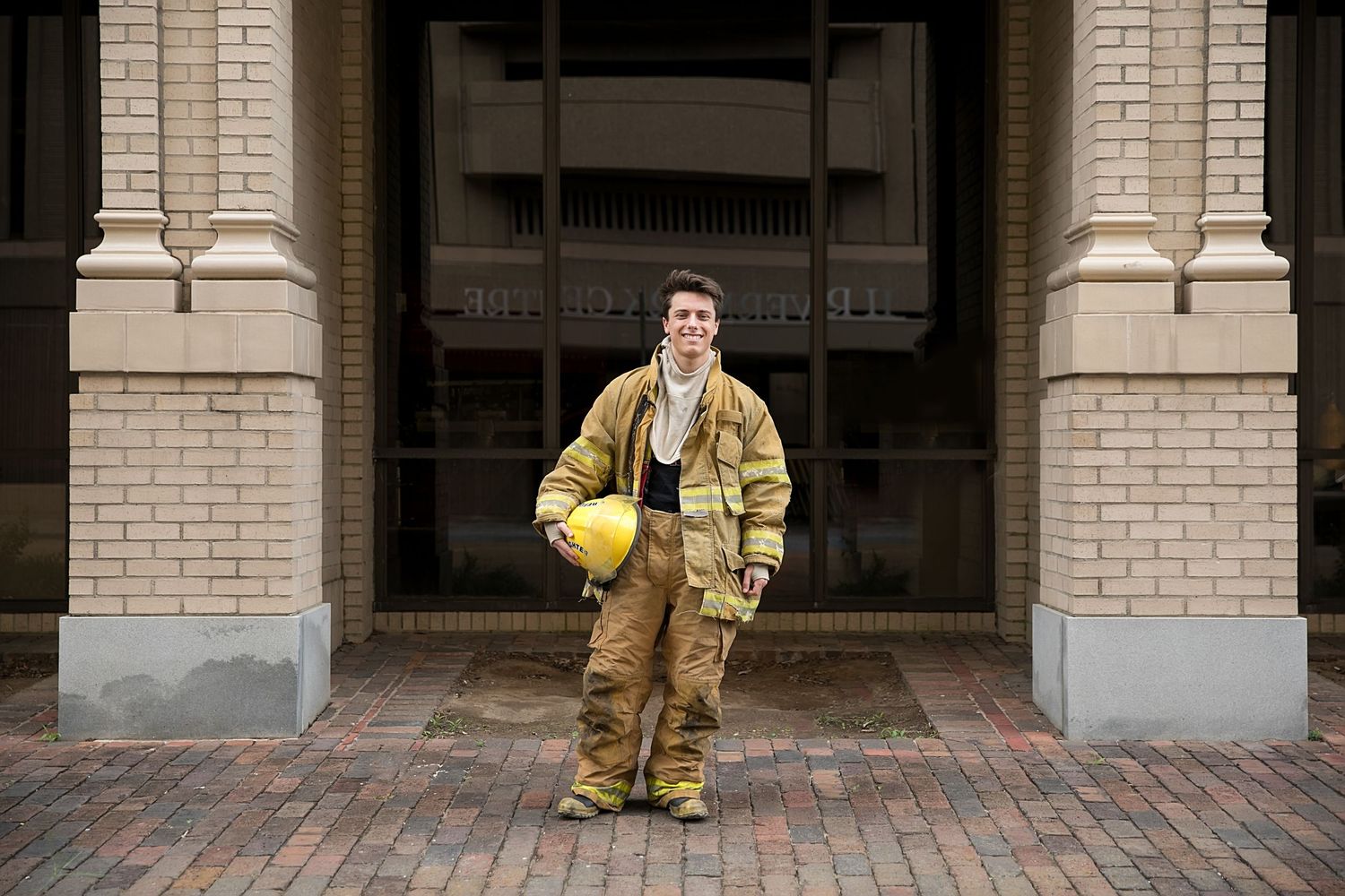 High School Senior Portraits of senior in fireman's uniform in Baton Rouge