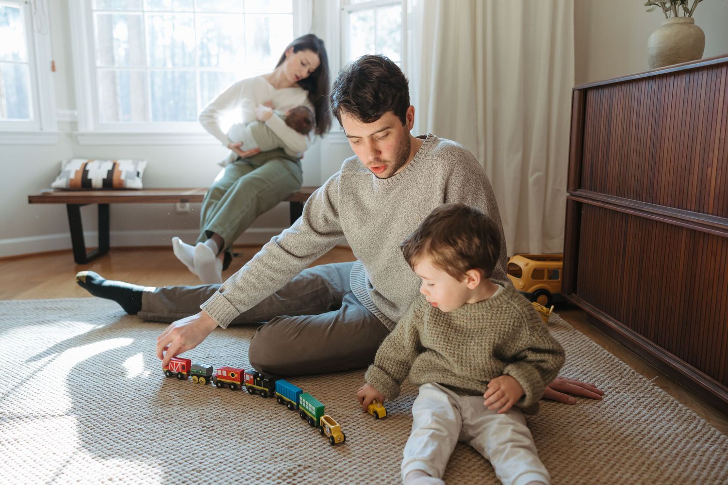 A series of five connected photos showing a child and parent playing together with toys on a carpeted floor.