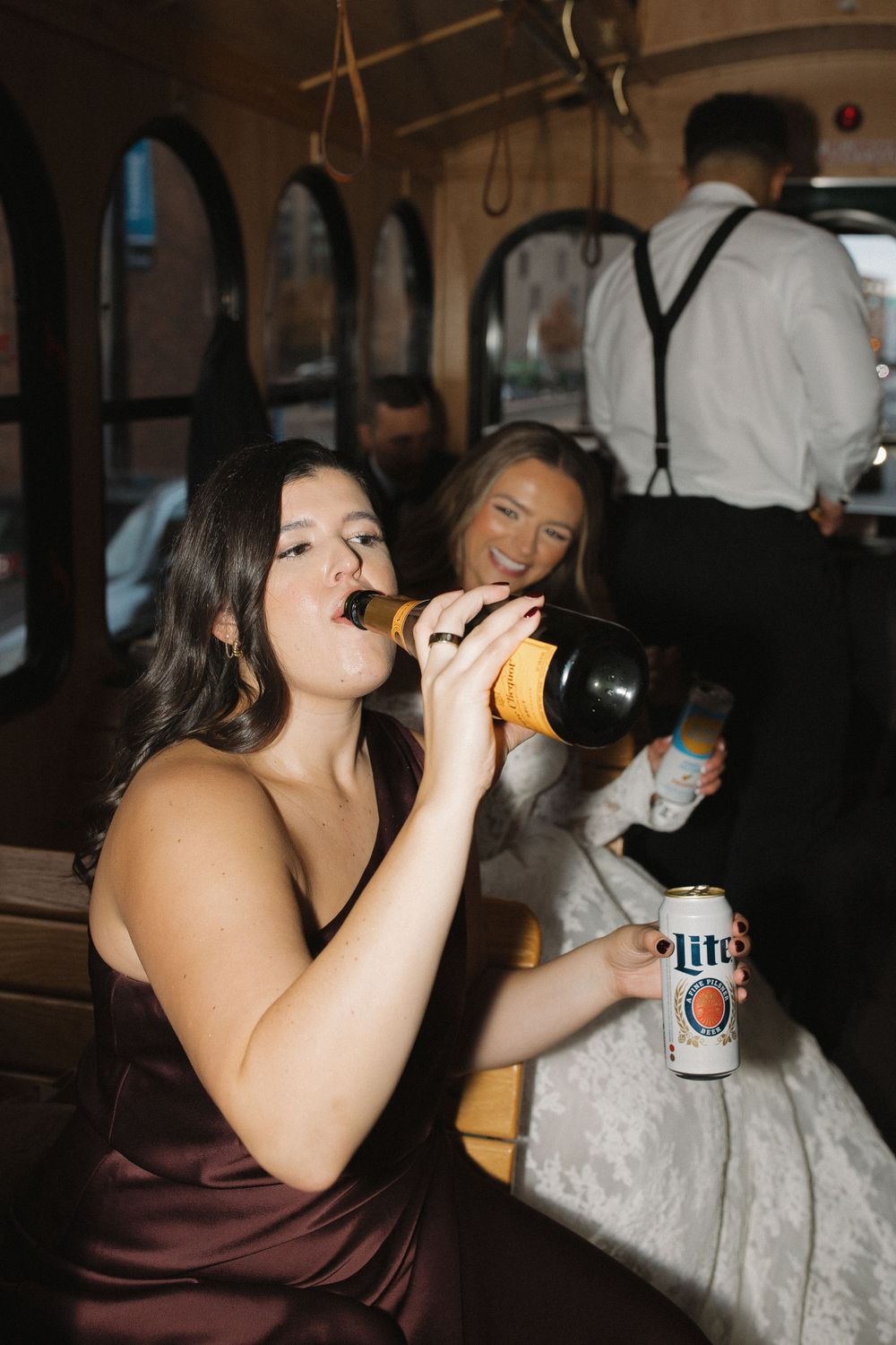 Four sequential photos show someone in a brown top drinking from a bottle in a dimly lit setting.