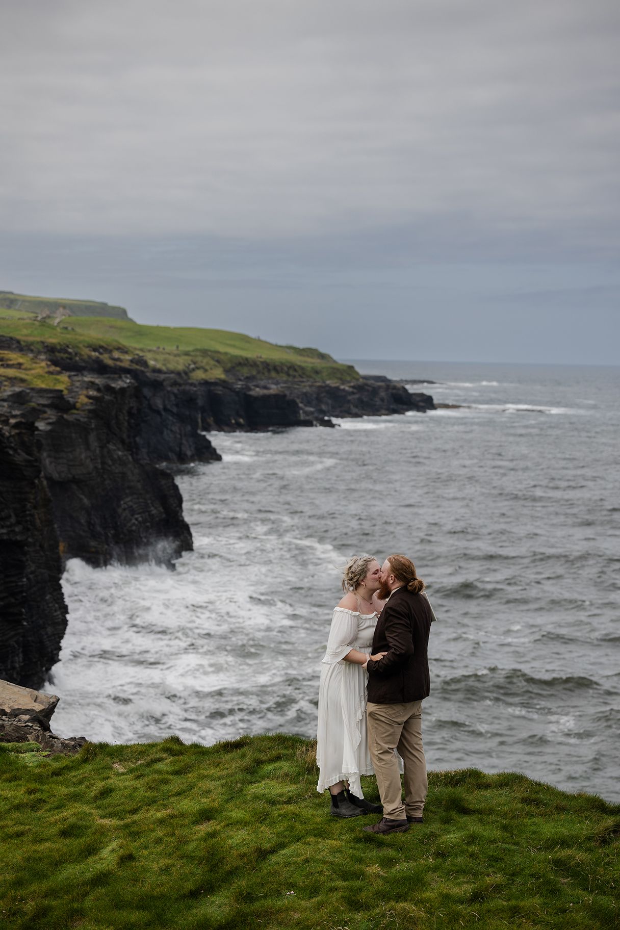 Intimate vow exchange during sunny Wild Atlantic Way elopement overlooking limestone sea cliffs