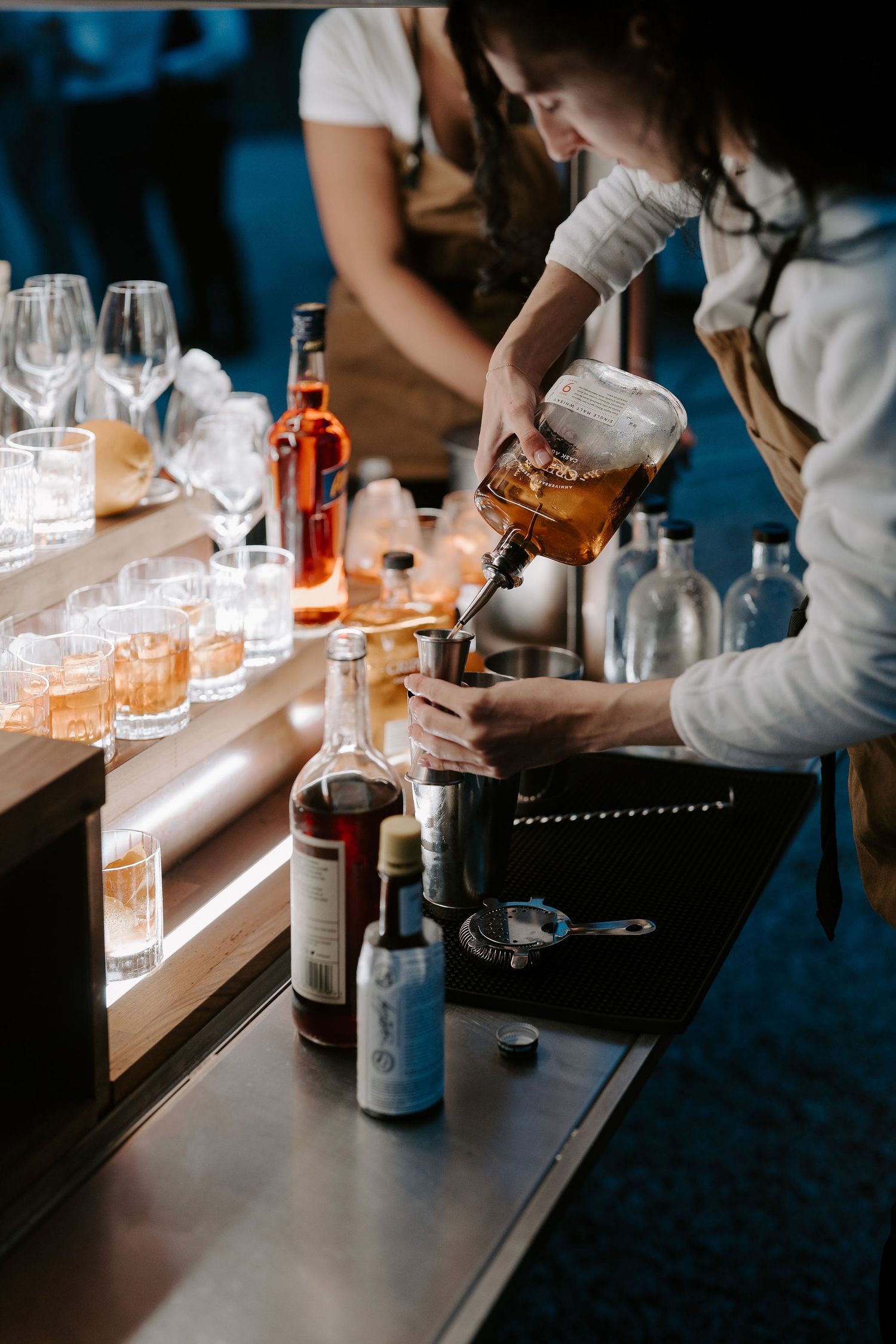 cocktails being poured at ivy lodge wedding in Cirencester