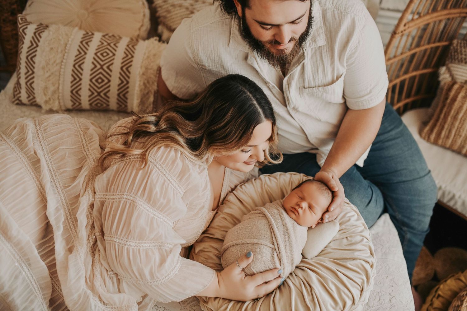 Mom and dad sharing a quiet moment with their newborn at home