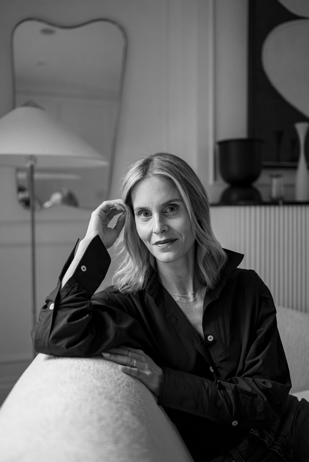 A series of black and white portraits showing someone wearing a black shirt while seated against a light background.
