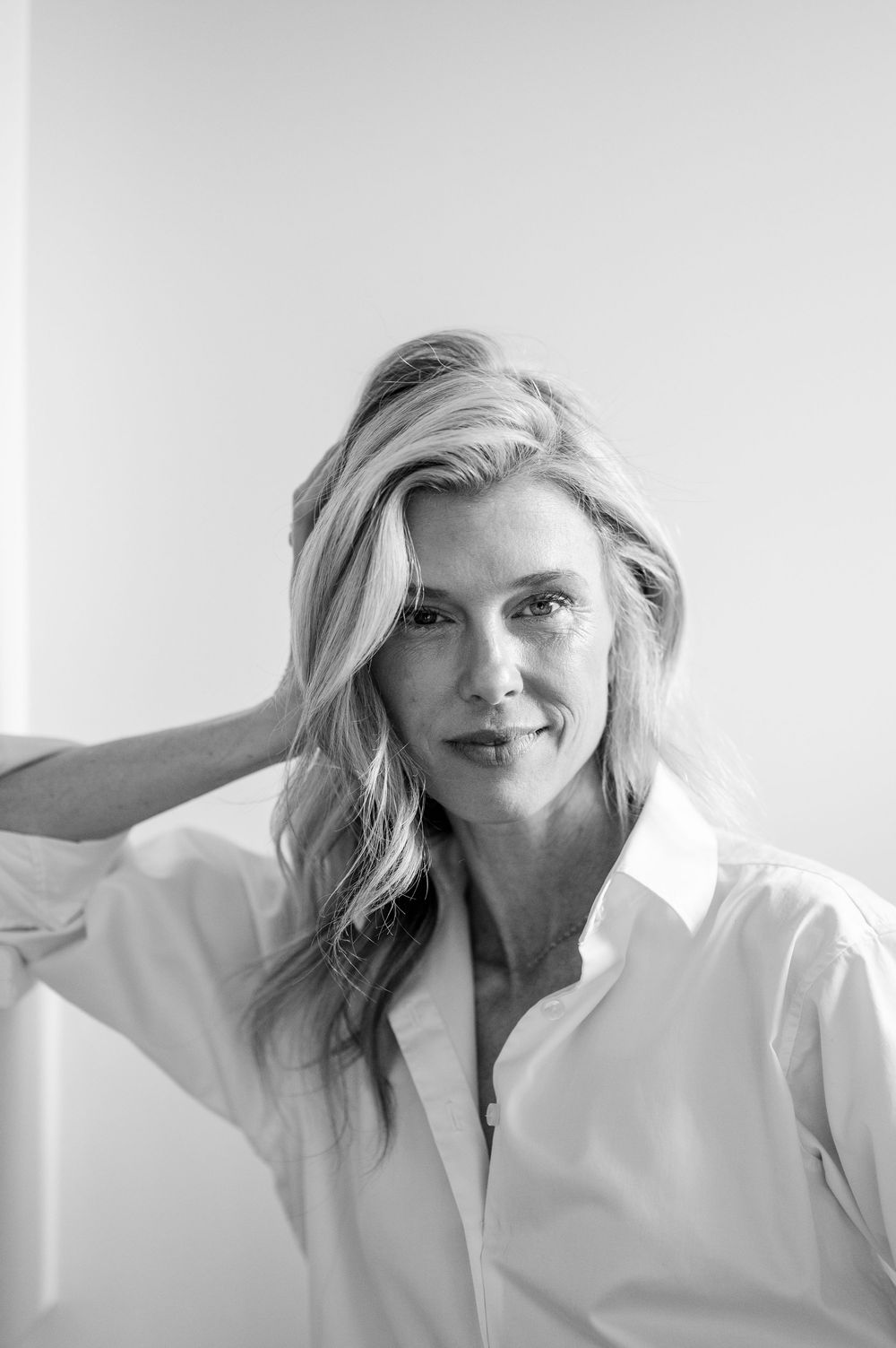 Black and white portrait series showing a person in a white button-up shirt against a light background.