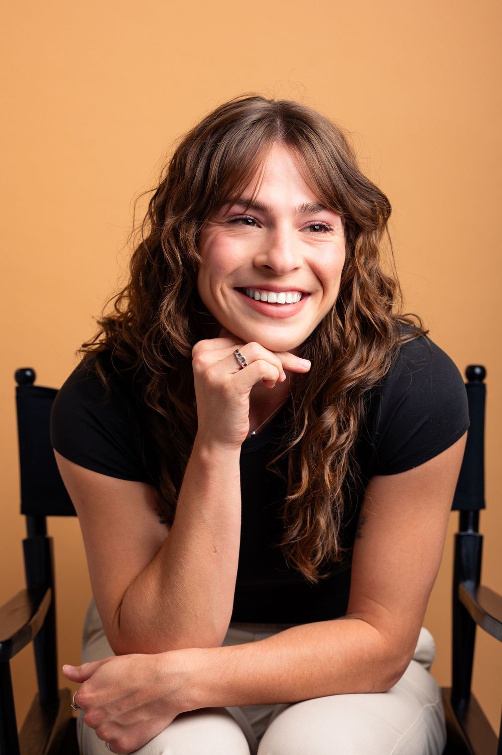 A series of five progressive shots showing someone with wavy brown hair resting on a chair against a peach-colored background.