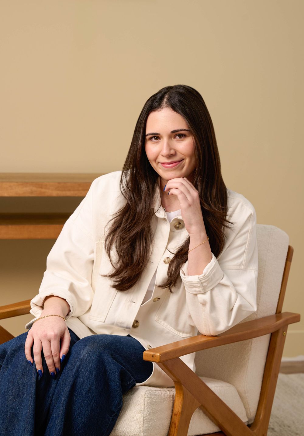 A series of four photos showing someone in a white shirt and jeans sitting casually in a wooden chair.