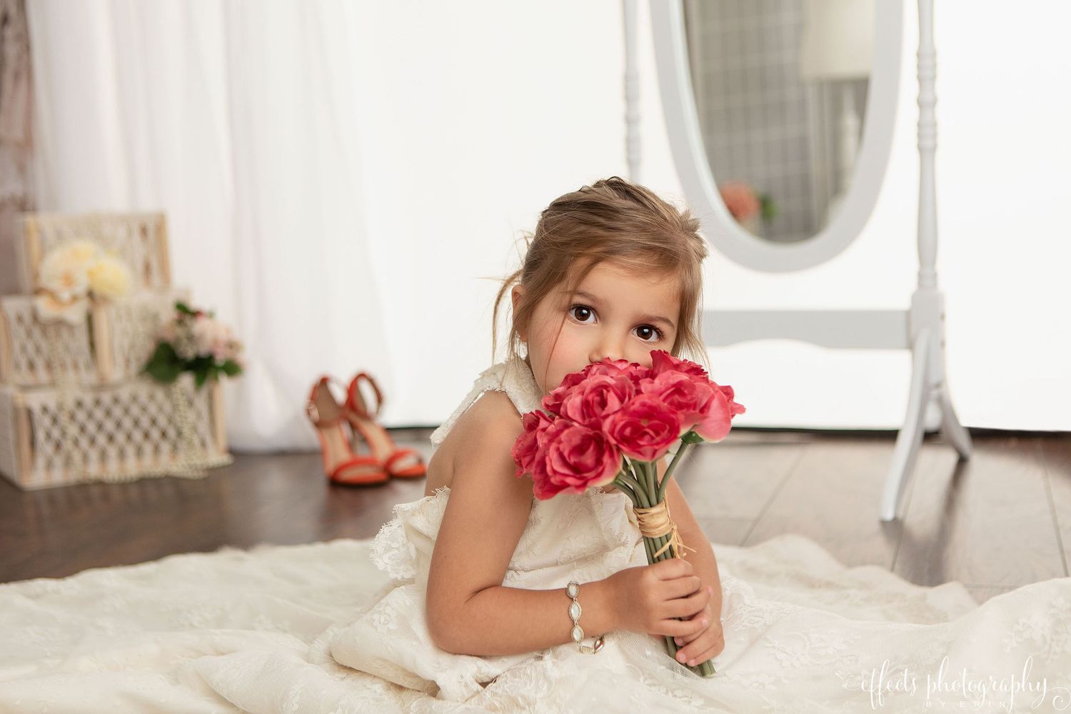 A wedding dress collection displayed in a bridal boutique with white gowns and elegant decor.