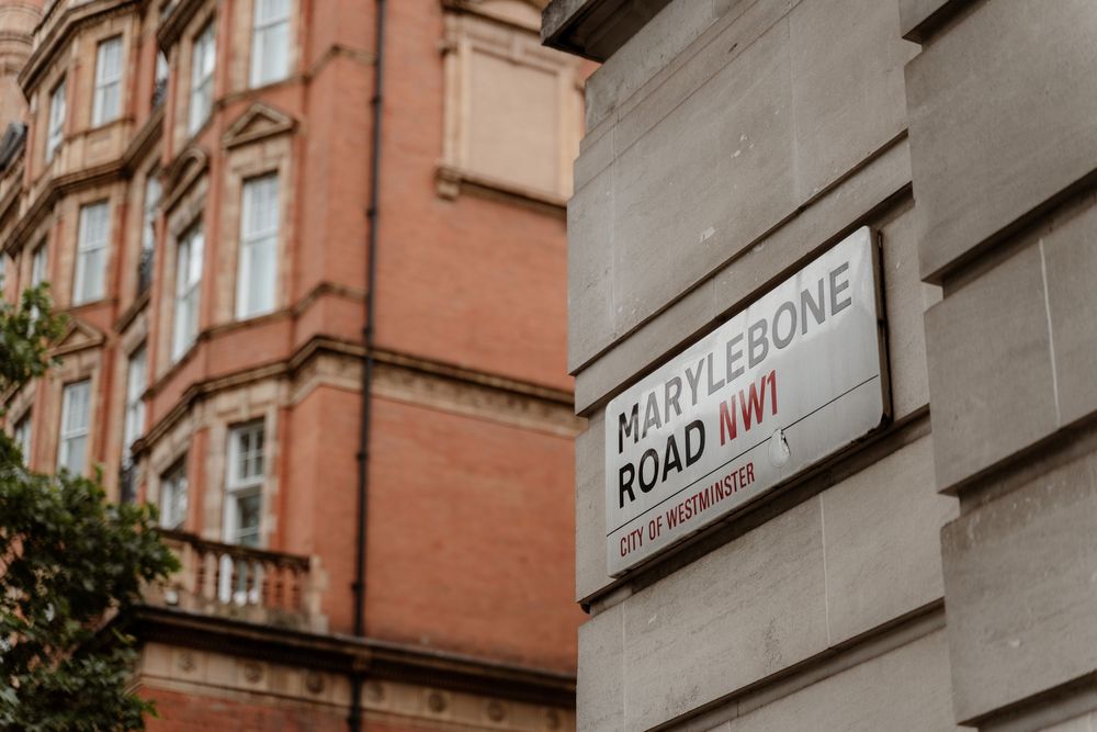 Vintage street sign for Bayfront Road mounted on a red brick building with traditional architecture.