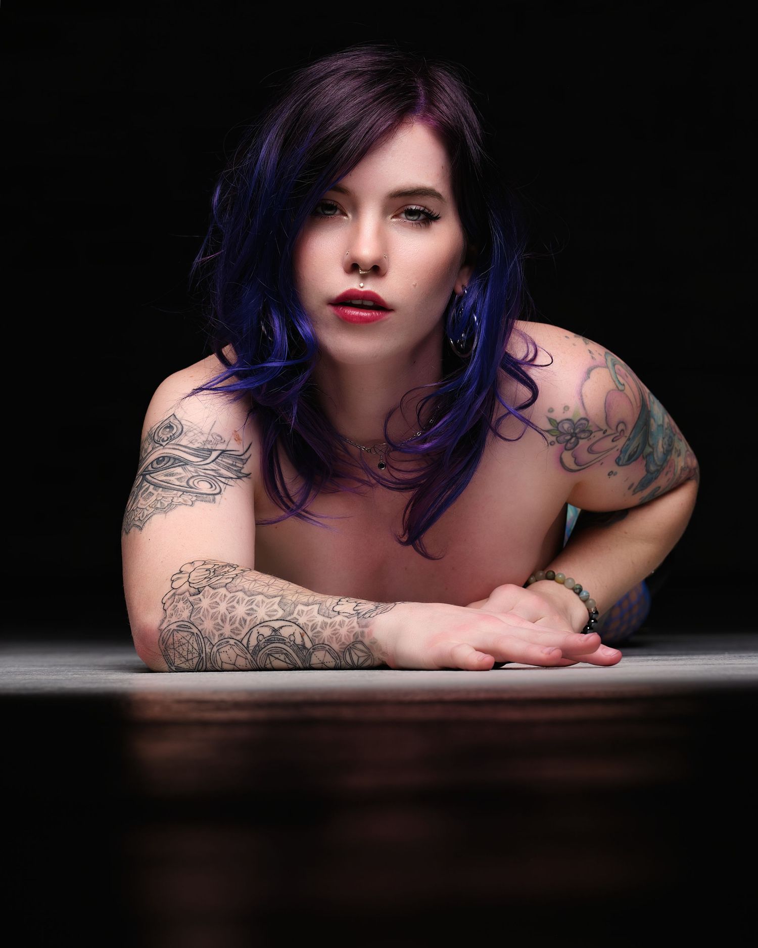 David G Holt Photography - Artistic portrait featuring vibrant blue hair and decorative tattoos in moody lighting.