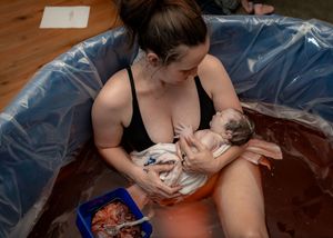 Natural birth photography documenting baby's arrival