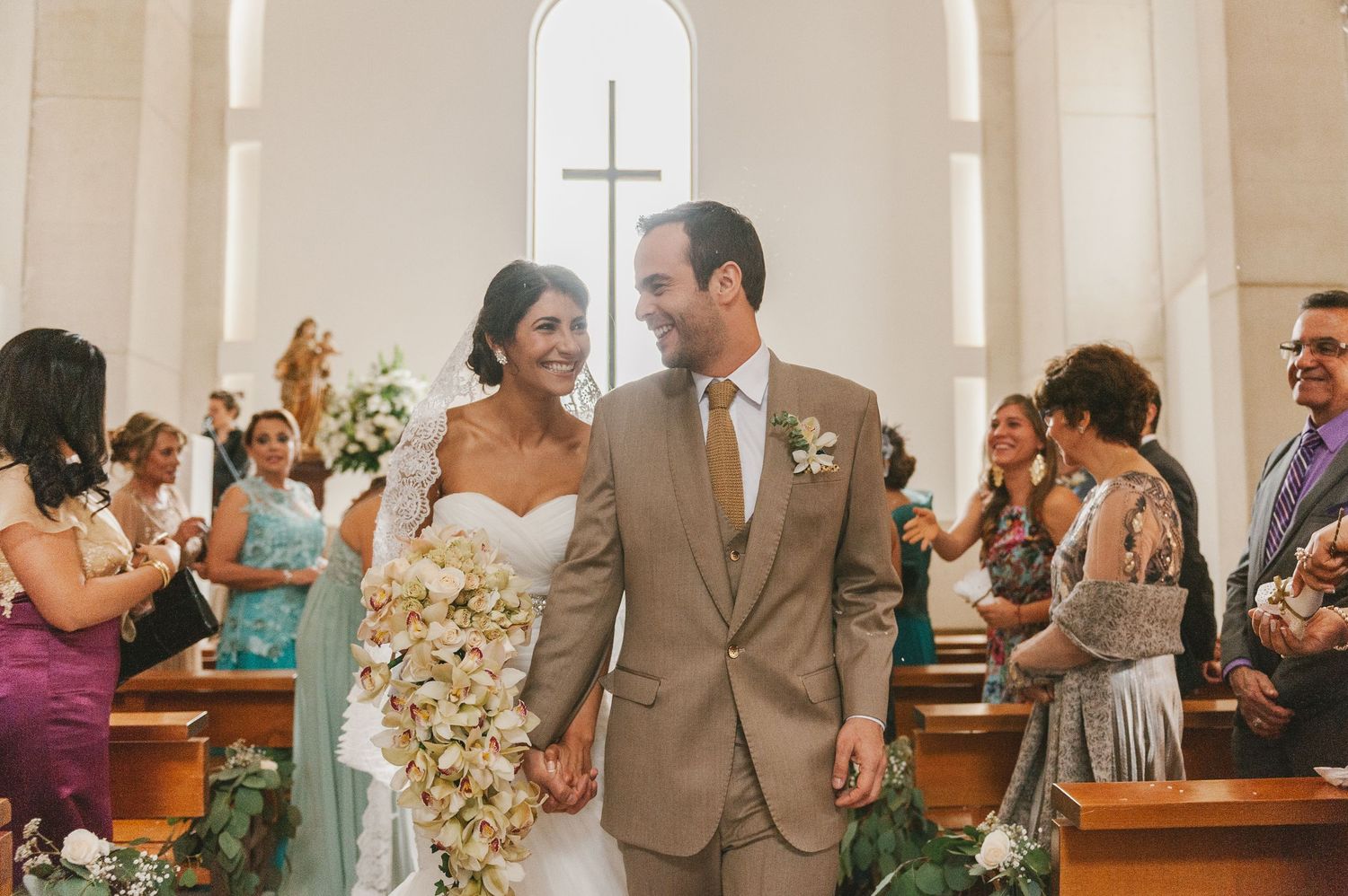 Newlyweds walk out of the church after the wedding ceremony in Colombia.