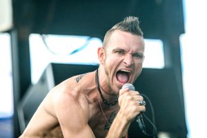 Passionate vocal performance on stage with dramatic expression.