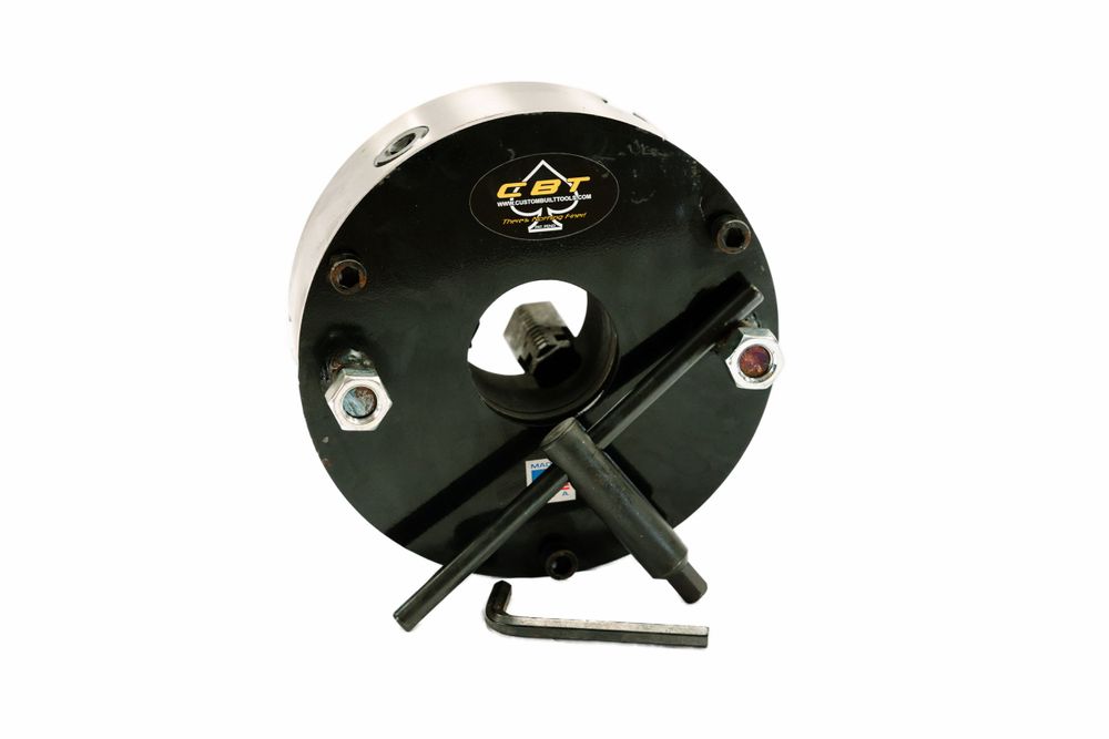 Black circular mechanical device with adjustment handles and knobs.