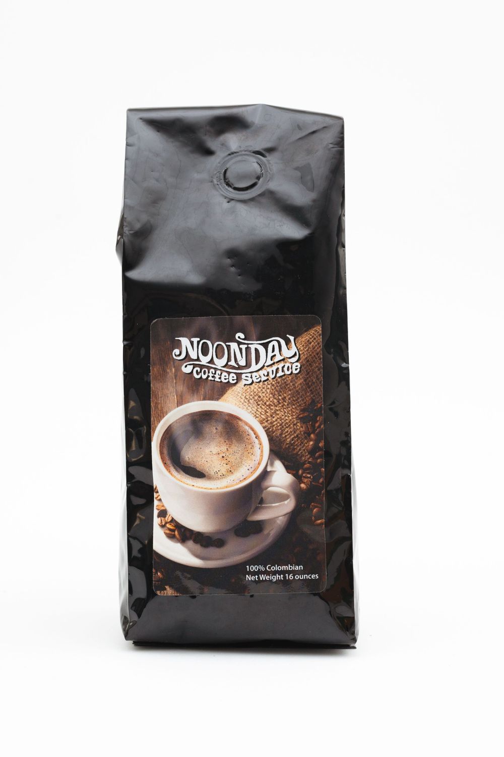 Black bag of Noon Day coffee featuring a steaming cup of coffee on the packaging.