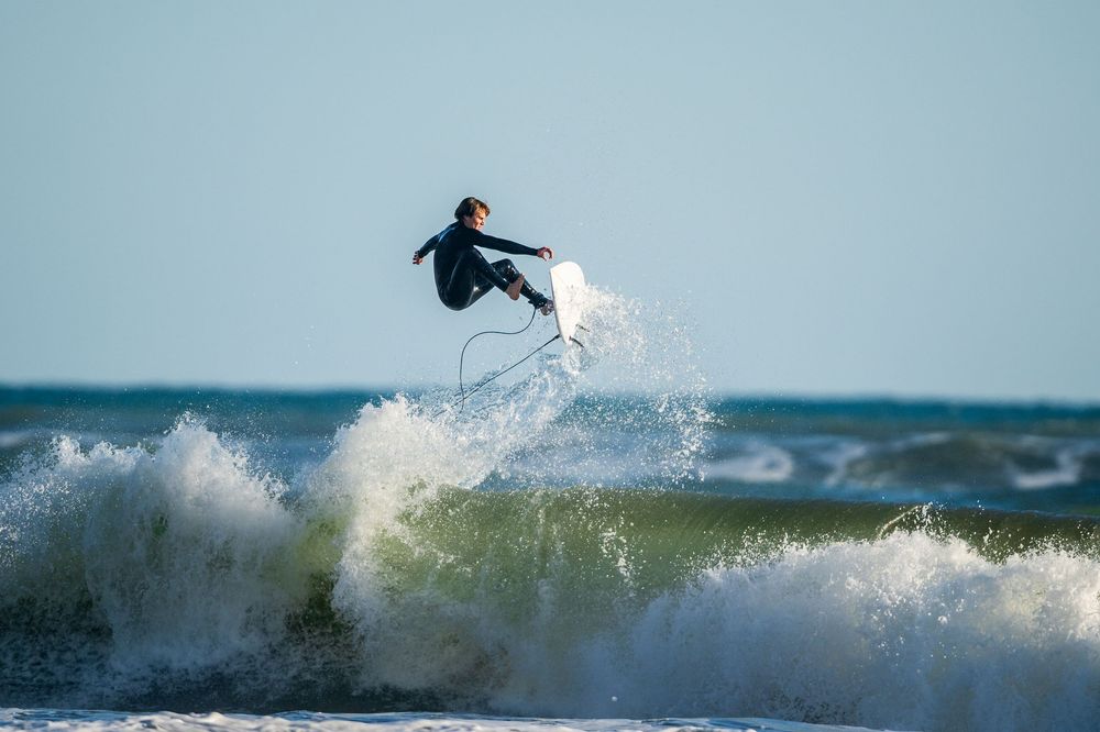 A surfer performs aerial maneuvers above ocean waves in a series of connected action shots.