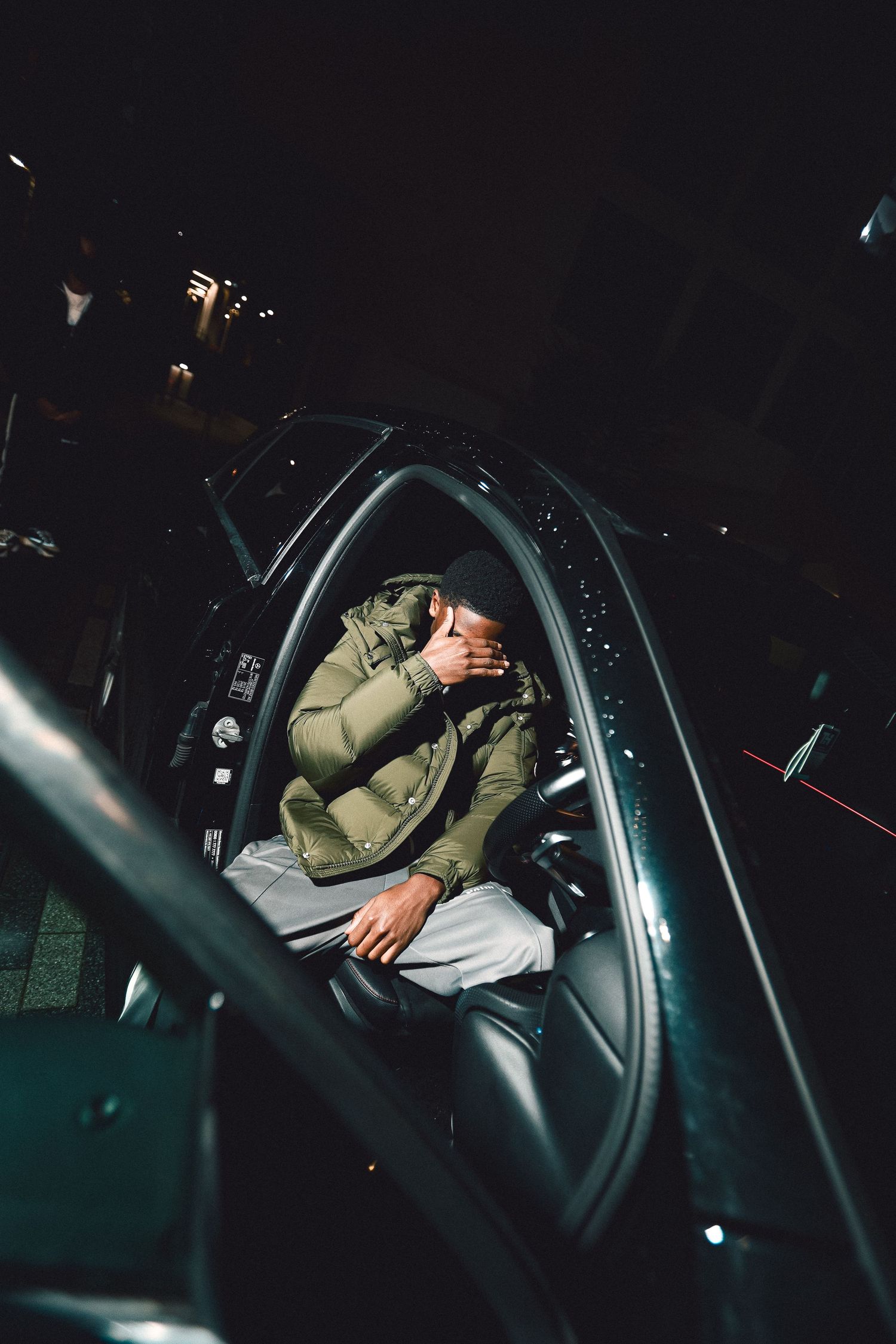 Four sequential photos showing someone sleeping in the driver's seat of a parked car at night.