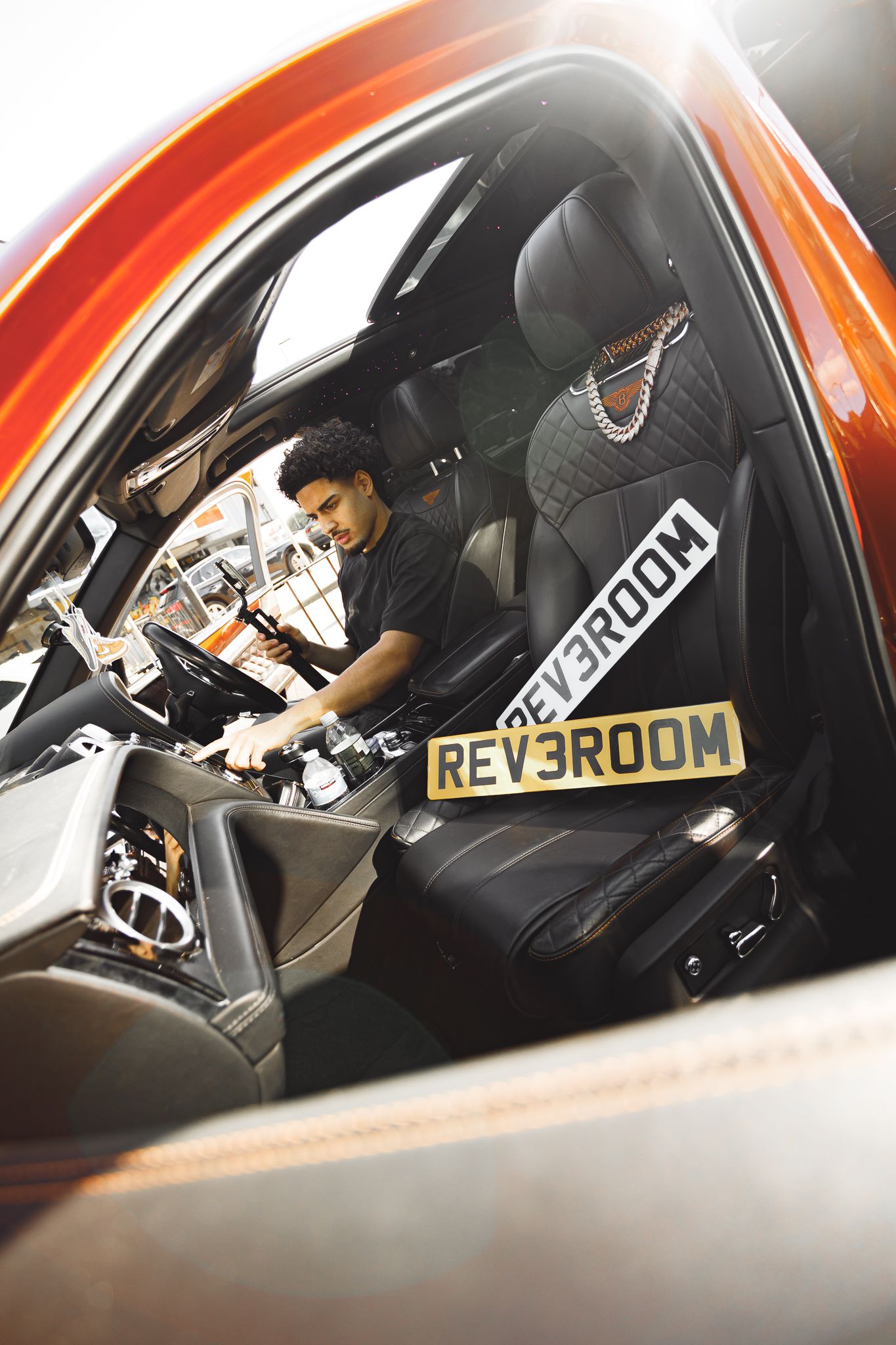 A sequence of interior car shots showing the driver's side window and dashboard in an orange-tinted vehicle.