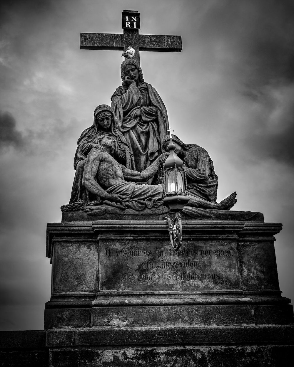 Three dramatic black and white photos of religious statuary and crosses against a dark moody sky with vignette effects.